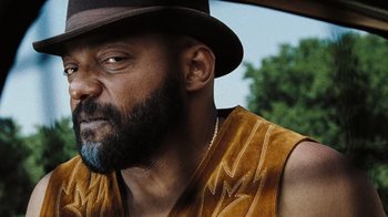 Movie still from “The Devil's Rejects” (2005), directed by Rob Zombie – A person wearing a hat; Close Up shot, Low angle