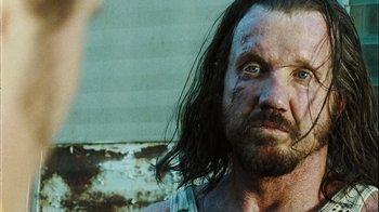 Movie still from “The Devil's Rejects” (2005), directed by Rob Zombie – A person with long hair; Close Up shot, Over the shoulder angle