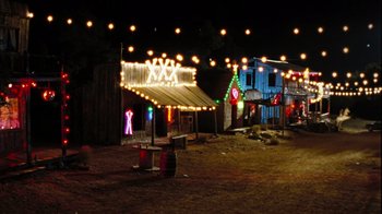 Movie still from “The Devil's Rejects” (2005), directed by Rob Zombie – A lot of lights that are hanging in a field; Extreme Wide shot, High angle