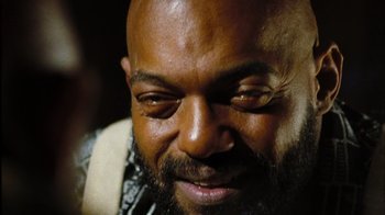 Movie still from “The Devil's Rejects” (2005), directed by Rob Zombie – A person with a beard; Extreme Close Up shot, Low angle