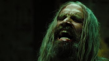 Movie still from “The Devil's Rejects” (2005), directed by Rob Zombie – A man with long hair and a long beard is screaming; Close Up shot, Low angle