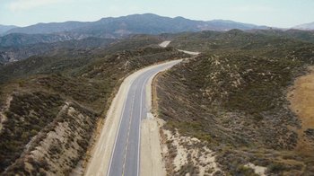 Movie still from “The Devil's Rejects” (2005), directed by Rob Zombie – An aerial view of an empty road in the middle of the desert; Extreme Wide shot, High angle