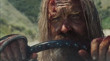 Movie still from “The Devil's Rejects” (2005), directed by Rob Zombie – A person holding a steering wheel; Close Up shot, Low angle