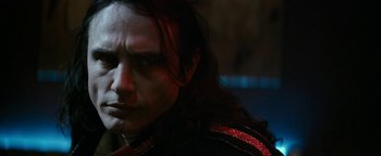 Movie still from “The Disaster Artist” (2017), directed by James Franco – A person with long black hair; Close Up shot, Over the shoulder angle