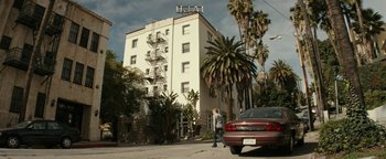 Movie still from “The Disaster Artist” (2017), directed by James Franco – A man walking down the street in front of an apartment building; Extreme Wide shot, Low angle