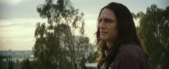 Movie still from “The Disaster Artist” (2017), directed by James Franco – A person with long brown hair; Close Up shot, Over the shoulder angle