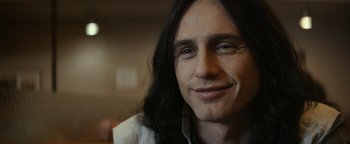 Movie still from “The Disaster Artist” (2017), directed by James Franco – A person with long black hair; Close Up shot, Over the shoulder angle