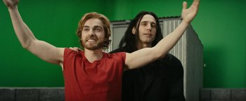 Movie still from “The Disaster Artist” (2017), directed by James Franco – A man with long hair and a man with short hair; Medium shot, Over the shoulder angle