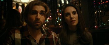 Movie still from “The Disaster Artist” (2017), directed by James Franco – A man and a woman sitting next to each other in front of lights; Close Up shot, Over the shoulder angle