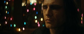 Movie still from “The Disaster Artist” (2017), directed by James Franco – A man's face in front of a christmas tree; Close Up shot, Low angle