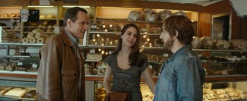 Movie still from “The Disaster Artist” (2017), directed by James Franco – Three people standing in front of a bakery; Medium shot, Over the shoulder angle