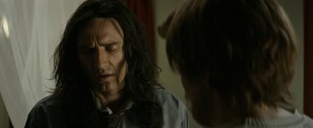 Movie still from “The Disaster Artist” (2017), directed by James Franco – A man with long black hair is looking at another man with long black hair; Close Up shot, Over the shoulder angle