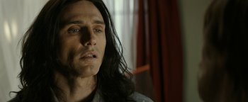 Movie still from “The Disaster Artist” (2017), directed by James Franco – A person with long black hair; Close Up shot, Over the shoulder angle