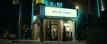 Movie still from “The Disaster Artist” (2017), directed by James Franco – A man standing in front of a movie theater; Extreme Wide shot, Low angle