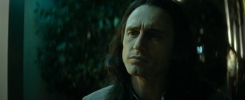 Movie still from “The Disaster Artist” (2017), directed by James Franco – A person with long black hair; Close Up shot, Over the shoulder angle