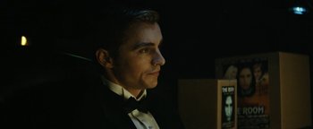 Movie still from “The Disaster Artist” (2017), directed by James Franco – A person wearing a suit and a bow tie; Close Up shot, Low angle