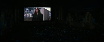 Movie still from “The Disaster Artist” (2017), directed by James Franco – People are sitting in a movie theater watching a movie; Wide shot, Over the shoulder angle