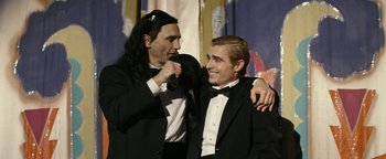 Movie still from “The Disaster Artist” (2017), directed by James Franco – Two men dressed up in tuxedos and bow ties; Medium shot, Over the shoulder angle