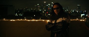 Movie still from “The Disaster Artist” (2017), directed by James Franco – A man standing next to a wall with lights; Medium shot, Over the shoulder angle