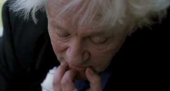 Movie still from “The Diving Bell and the Butterfly” (2007), directed by Julian Schnabel – An older man with white hair is looking down; Extreme Close Up shot, High angle