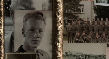 Movie still from “The Diving Bell and the Butterfly” (2007), directed by Julian Schnabel – An old picture of a boy and a group of soldiers; Extreme Close Up shot, High angle