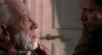 Movie still from “The Diving Bell and the Butterfly” (2007), directed by Julian Schnabel – An older man is shaving his face in the bathroom; Close Up shot, Over the shoulder angle