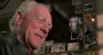 Movie still from “The Diving Bell and the Butterfly” (2007), directed by Julian Schnabel – An older man is looking down at his face; Close Up shot, Over the shoulder angle