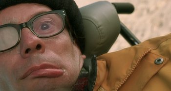 Movie still from “The Diving Bell and the Butterfly” (2007), directed by Julian Schnabel – A person wearing glasses and a jacket; Close Up shot, Overhead angle