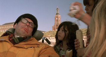 Movie still from “The Diving Bell and the Butterfly” (2007), directed by Julian Schnabel – A man and a little girl in front of a clock tower; Close Up shot, Low angle