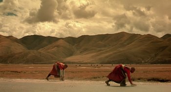Movie still from “The Diving Bell and the Butterfly” (2007), directed by Julian Schnabel – Two monks are walking down the street in the desert; Extreme Wide shot, Low angle
