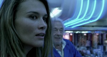 Movie still from “The Diving Bell and the Butterfly” (2007), directed by Julian Schnabel – A woman and an old man are standing in a room; Close Up shot, Over the shoulder angle