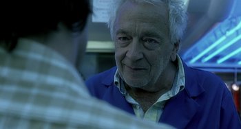 Movie still from “The Diving Bell and the Butterfly” (2007), directed by Julian Schnabel – An older man with white hair talking to a younger man; Close Up shot, Over the shoulder angle