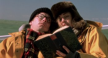 Movie still from “The Diving Bell and the Butterfly” (2007), directed by Julian Schnabel – A man and a woman are reading a book together; Close Up shot, Low angle