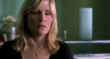 Movie still from “The Diving Bell and the Butterfly” (2007), directed by Julian Schnabel – A person wearing a necklace; Close Up shot, Over the shoulder angle