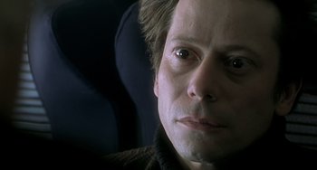 Movie still from “The Diving Bell and the Butterfly” (2007), directed by Julian Schnabel – A man's face in a car seat; Close Up shot, Low angle