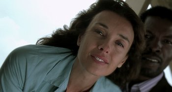 Movie still from “The Diving Bell and the Butterfly” (2007), directed by Julian Schnabel – A woman's face in a blue shirt; Close Up shot, Low angle