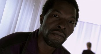 Movie still from “The Diving Bell and the Butterfly” (2007), directed by Julian Schnabel – A man's face in front of a window; Close Up shot, Low angle