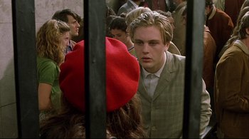 Movie still from “The Dreamers” (2003), directed by Bernardo Bertolucci – A group of people standing next to each other in a room; Close Up shot, Over the shoulder angle