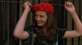 Movie still from “The Dreamers” (2003), directed by Bernardo Bertolucci – A woman in a green dress wearing a red hat; Close Up shot, Low angle