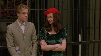 Movie still from “The Dreamers” (2003), directed by Bernardo Bertolucci – A woman in a red hat and a man in a suit; Medium shot, Low angle