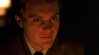 Movie still from “The Dreamers” (2003), directed by Bernardo Bertolucci – A young man in a suit and tie looking at the camera; Close Up shot, Low angle