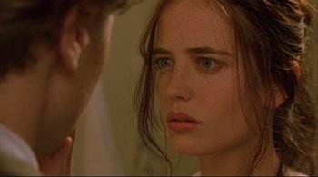 Movie still from “The Dreamers” (2003), directed by Bernardo Bertolucci – A woman looking into a mirror while standing next to a man; Close Up shot, Over the shoulder angle