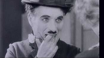 Movie still from “The Dreamers” (2003), directed by Bernardo Bertolucci – An old black and white photo of a man with a mustache; Close Up shot, Low angle