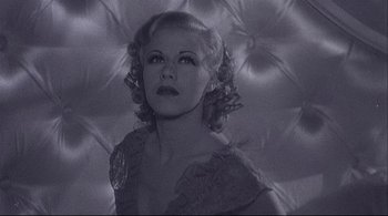 Movie still from “The Dreamers” (2003), directed by Bernardo Bertolucci – An old photo of a woman in a black dress; Close Up shot, Low angle