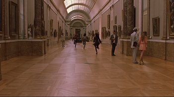 Movie still from “The Dreamers” (2003), directed by Bernardo Bertolucci – A group of people walking in an art gallery; Extreme Wide shot, High angle