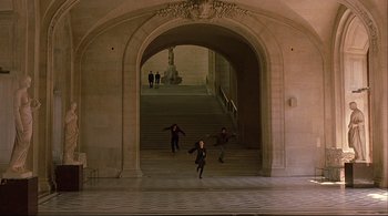 Movie still from “The Dreamers” (2003), directed by Bernardo Bertolucci – A group of people running down the steps of a building; Extreme Wide shot, High angle