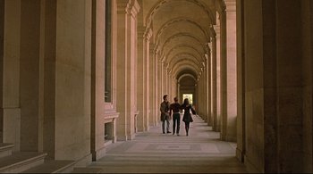 Movie still from “The Dreamers” (2003), directed by Bernardo Bertolucci – A group of people walking down a long hallway; Extreme Wide shot, High angle