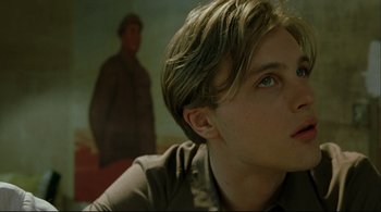 Movie still from “The Dreamers” (2003), directed by Bernardo Bertolucci – A young man with blue eyes stares into the distance; Close Up shot, Low angle