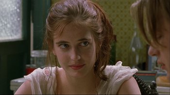 Movie still from “The Dreamers” (2003), directed by Bernardo Bertolucci – A young woman is looking into the camera; Close Up shot, Over the shoulder angle