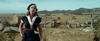 Movie still from “The Dressmaker” (2015), directed by Jocelyn Moorhouse – A woman standing in the middle of an open field; Medium shot, Low angle